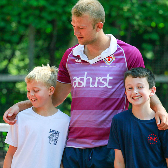 Summer camp staff helping kids