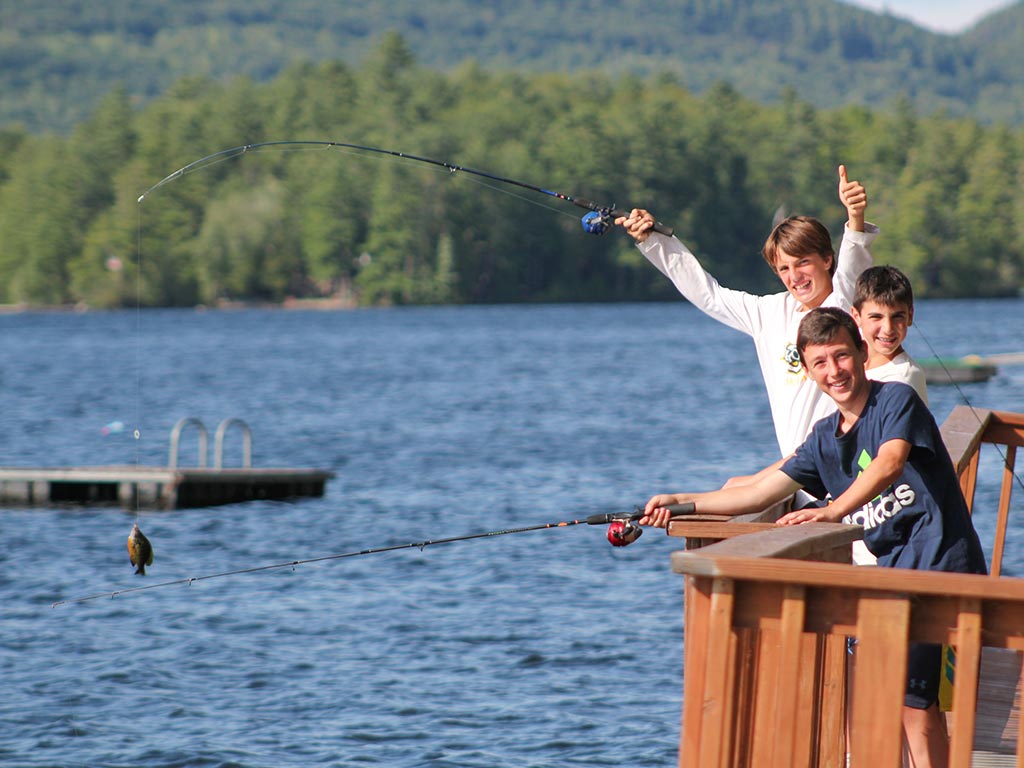 Fishing off the dock at summer camp